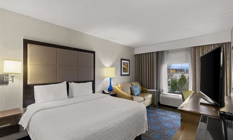 Comfortable king room with sofa and work desk at Hampton Inn Bloomington.