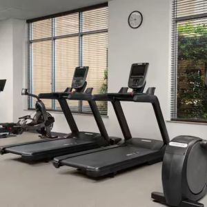 Fitness center with natural light at Hilton Garden Inn Fort Worth Medical Center.
