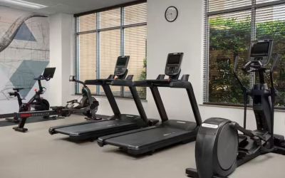 Fitness center with natural light at Hilton Garden Inn Fort Worth Medical Center.