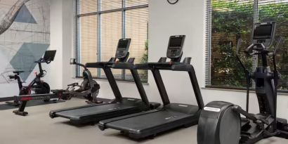 Fitness center with natural light at Hilton Garden Inn Fort Worth Medical Center.