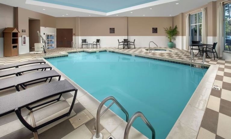 Refreshing indoor pool with loungers at Embassy Suites By Hilton Birmingham.