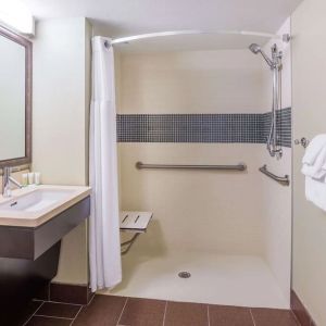 Accessible private guest bathroom with shower at Sonesta ES Suites Atlanta - Perimeter Center.