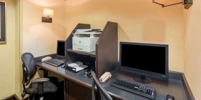 Business center with computers, printer and ergonomic chairs 	at Sonesta ES Suites Atlanta - Perimeter Center.