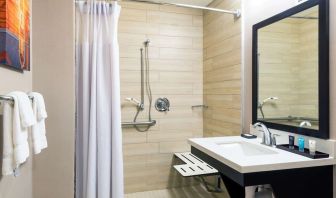 Accessible private guest bathroom with shower at Sonesta Atlanta Airport North.