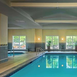 Indoor pool with lounge chairs at Sonesta Atlanta Airport South.