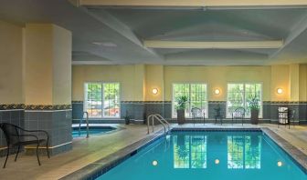 Indoor pool with lounge chairs at Sonesta Atlanta Airport South.