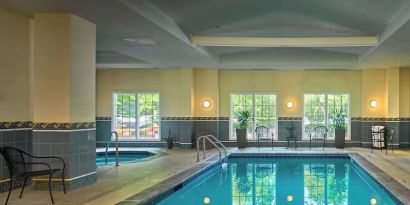 Indoor pool with lounge chairs at Sonesta Atlanta Airport South.