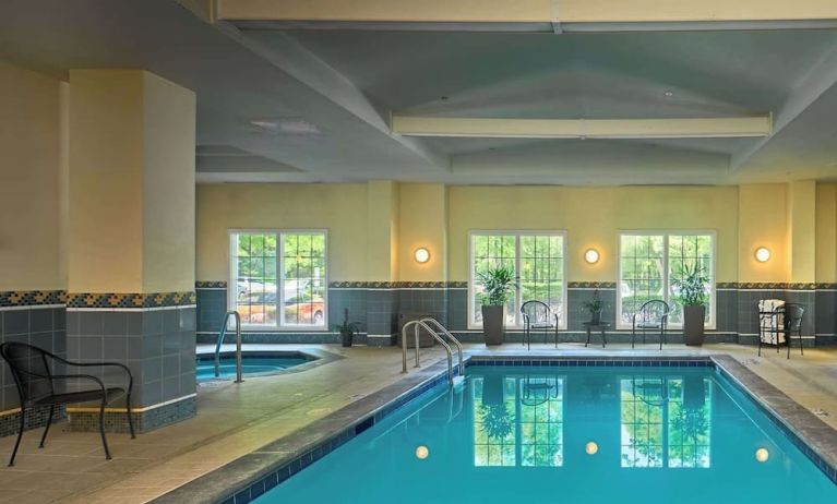 Indoor pool with lounge chairs at Sonesta Atlanta Airport South.