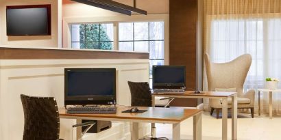 Business center with computers, printer and comfortable seating at Sonesta Atlanta Airport South.
