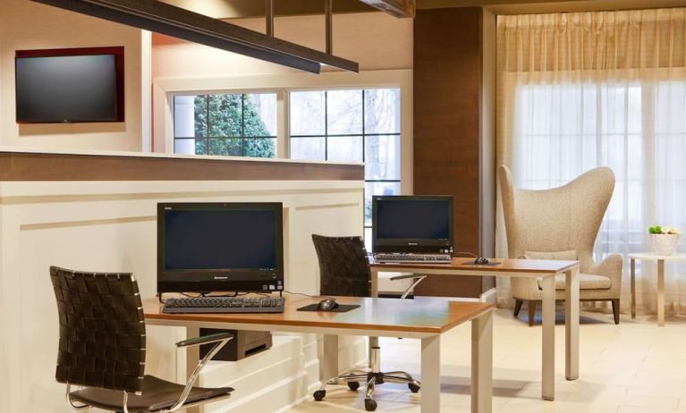 Business center with computers, printer and comfortable seating at Sonesta Atlanta Airport South.