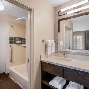 Private guest bathroom with combined shower and tub at Sonesta ES Suites Denver South - Park Meadows.