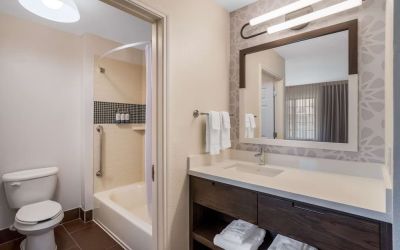 Private guest bathroom with combined shower and tub at Sonesta ES Suites Denver South - Park Meadows.