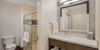 Private guest bathroom with shower and free toiletries at Sonesta ES Suites Denver South - Park Meadows.