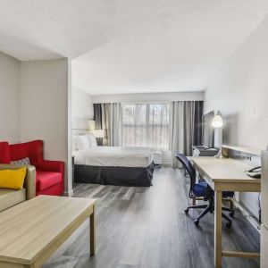 Day use room with work desk and living area at Country Inn & Suites By Radisson, Chicago O'Hare South.