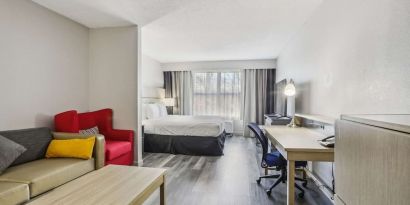 Day use room with work desk and living area at Country Inn & Suites By Radisson, Chicago O'Hare South.