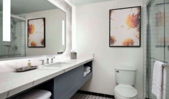 Private guest bathroom with shower and free toiletries at Sonesta Los Angeles Airport LAX.