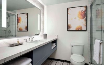 Private guest bathroom with shower and free toiletries at Sonesta Los Angeles Airport LAX.
