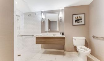 Private guest bathroom with shower and free toiletries at Sonesta Anaheim Resort Area.