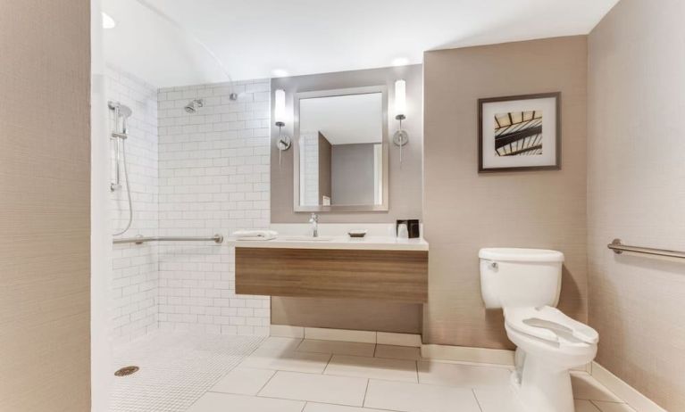 Private guest bathroom with shower and free toiletries at Sonesta Anaheim Resort Area.