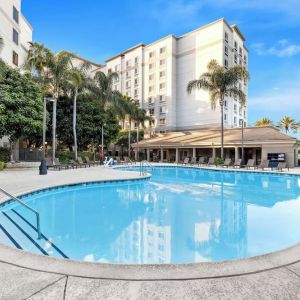 Outdoor pool with lounge area at Sonesta Anaheim Resort Area.