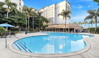 Outdoor pool with lounge area at Sonesta Anaheim Resort Area.
