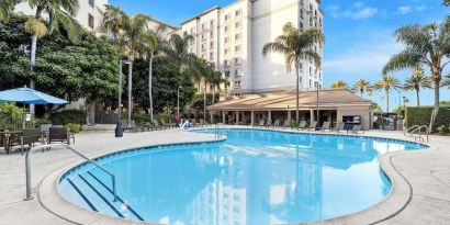 Outdoor pool with lounge area at Sonesta Anaheim Resort Area.