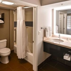 Private guest bathroom with combined shower and tub at Sonesta ES Suites San Antonio Northwest - Medical Center.
