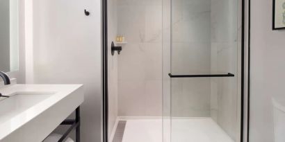 Private guest bathroom with shower at The Clift Royal Sonesta.