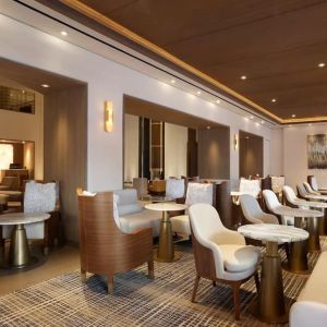 The hotel’s Living Room is furnished with comfortable seating and small tables, where guests can socialize, co-work, or have a drink.