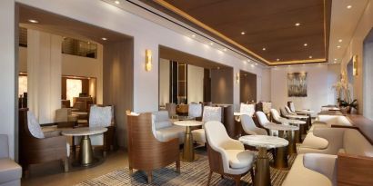 The hotel’s Living Room is furnished with comfortable seating and small tables, where guests can socialize, co-work, or have a drink.