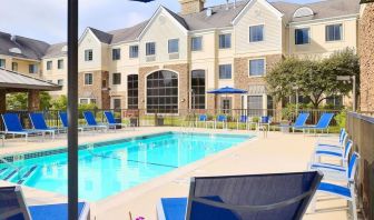 Outdoor pool with lounge chairs at Sonesta ES Suites Charlotte Arrowood.