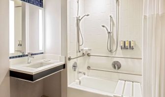 Private guest bathroom with combined shower and tub at Royal Sonesta Boston.