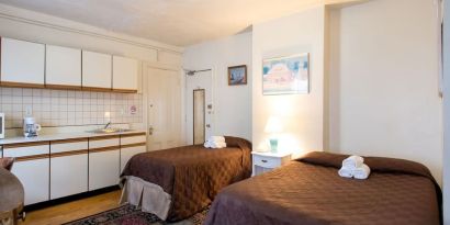 Day use twin room with in-room kitchen and work desk at The Farrington Inn.