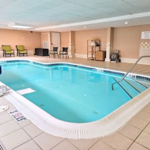 Relaxing indoor heated pool with lounge chairs at Holiday Inn Belcamp - Aberdeen Area.