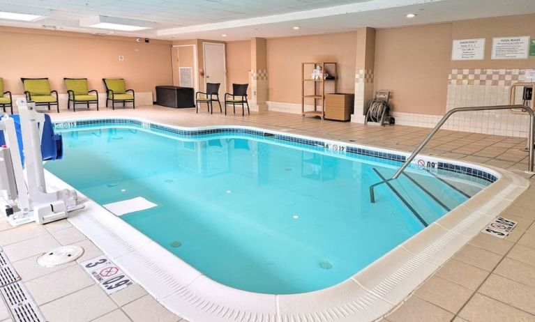 Relaxing indoor heated pool with lounge chairs at Holiday Inn Belcamp - Aberdeen Area.