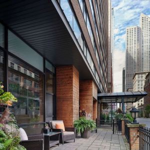 Hotel entrance and terrace with lounge seating at Sonesta ES Suites Chicago Downtown Magnificent Mile - Medical.