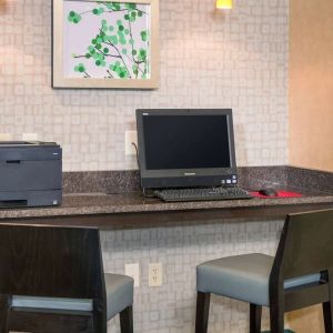 Business center with computer, printer and comfortable chairs at Sonesta ES Suites Charlottesville University.