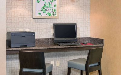 Business center with computer, printer and comfortable chairs at Sonesta ES Suites Charlottesville University.
