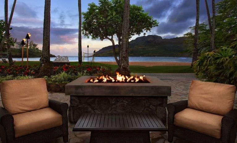 Hotel terrace with lounge seating and fire pit at Royal Sonesta Kaua'i Resort Lihue.