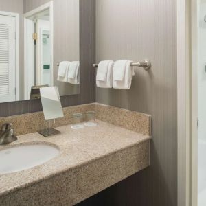 Private guest bathroom with combined shower/tub and free toiletries at Sonesta Select Seattle Bellevue Redmond.