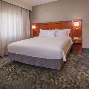 King bed at Sonesta Select Charlotte University Research Park.