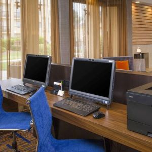 Business center with computers, printer and ergonomic chairs at Sonesta Select Charlotte University Research Park.