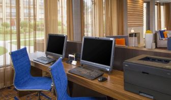 Business center with computers, printer and ergonomic chairs at Sonesta Select Charlotte University Research Park.