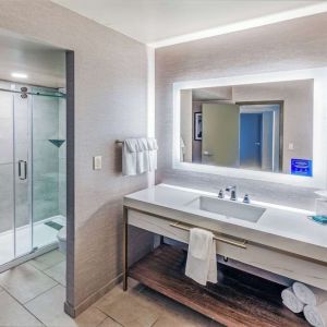 Guest bathroom with shower at DoubleTree By Hilton Tulsa-Downtown.
