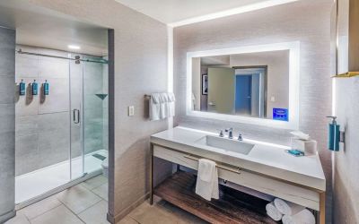 Guest bathroom with shower at DoubleTree By Hilton Tulsa-Downtown.
