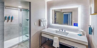 Guest bathroom with shower at DoubleTree By Hilton Tulsa-Downtown.
