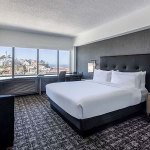 Day use room with sofa and work desk overlooking the city at Hilton San Francisco Financial District.
