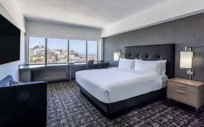 Day use room with sofa and work desk overlooking the city at Hilton San Francisco Financial District.