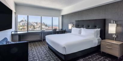 Day use room with sofa and work desk overlooking the city at Hilton San Francisco Financial District.