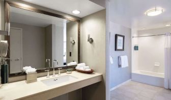 Guest bathroom with shower and tub at Hilton San Francisco Financial District.
